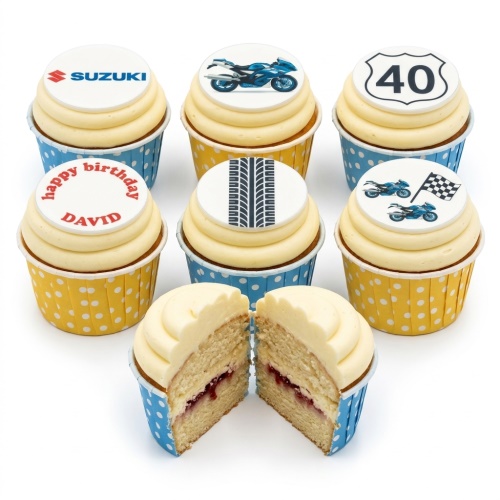 Set of motorbike themed birthday cupcakes with blue bikes, tire track, Suzuki logo, and custom age topper.