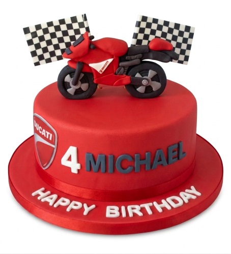 Red Ducati motorcycle theme birthday cake with edible bike, checkered flags, and custom age.