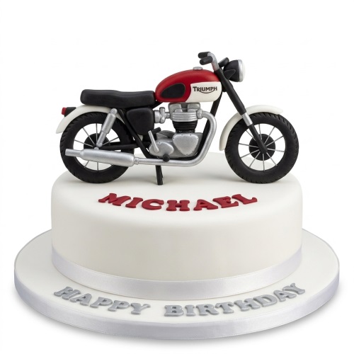 White round birthday cake with a red and white motorcycle topper and custom name.