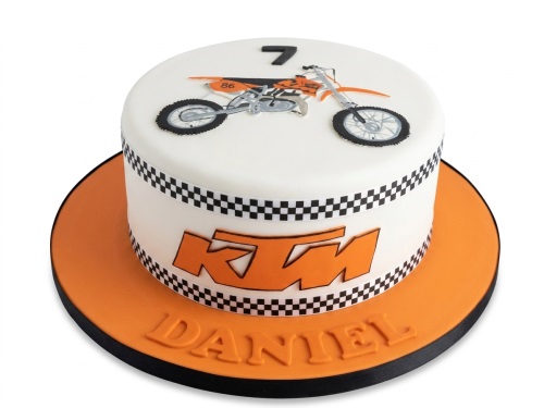 White and orange motocross birthday cake with a custom age topper and KTM logo.