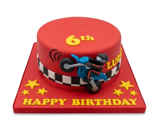 Red round birthday cake with a blue motorbike, rider, checkerboard, yellow stars, and custom age topper.