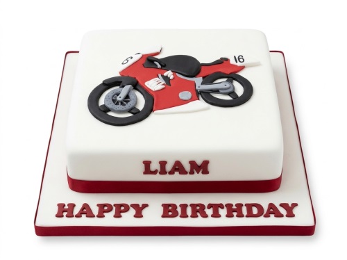 White square birthday cake with a red and black motorcycle fondant decoration and red ribbon.