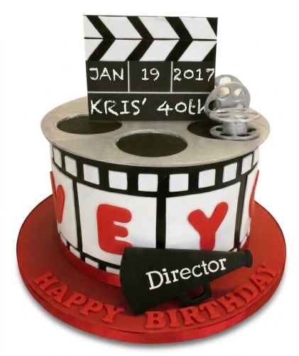 Movie theme birthday cake with clapperboard, film reel, megaphone, and custom age topper.