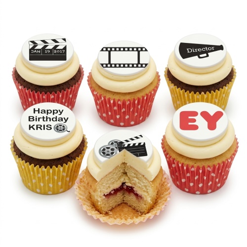 Six cupcakes with white buttercream and edible film theme toppers, including clapperboards, film reels, and a megaphone.