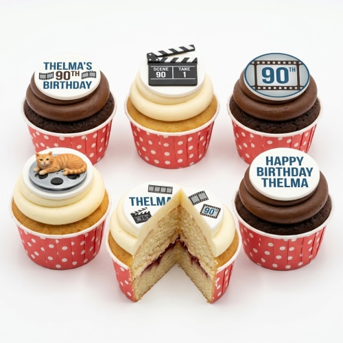 Six movie theme cupcakes with clapperboard, film reel, and film strip toppers, some with chocolate and vanilla frosting in red polka dot cases.