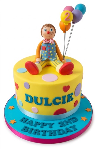 Mr Tumble character birthday cake with colourful balloons, polka dots, and a custom age topper.