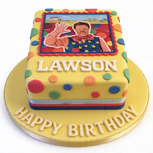 Yellow rectangular Mr Tumble birthday cake with colourful polka dots and a character image.