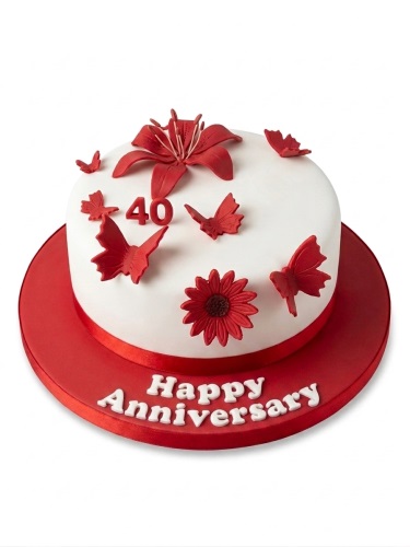 White round cake with red sugar flowers and butterflies, red ribbon, and a '40' topper.