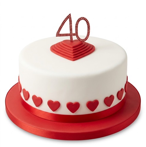 Round white cake with red heart decorations and a glittery custom age topper.