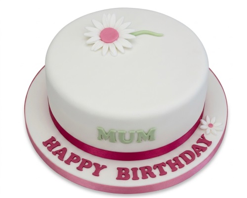 Round white birthday cake with pink ribbon and white daisy decorations, featuring a custom message.