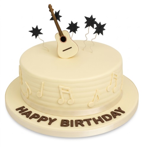 Round cream birthday cake with an edible guitar topper, black stars, and musical notes.