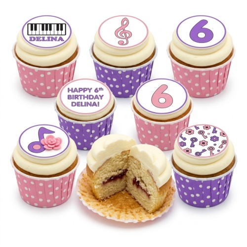 Assortment of pink and purple cupcakes with musical notes, piano keys, flowers, and custom age toppers.