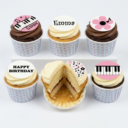 A set of six music-themed birthday cupcakes with piano keys and musical note toppers.