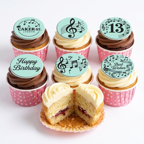 Six music theme birthday cupcakes with musical notes, treble clef, and custom age topper.
