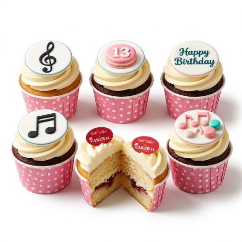 A set of music theme birthday cupcakes with musical notes, macarons, and 'Happy Birthday' toppers in pink and white wrappers.