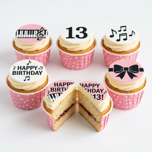 Pink birthday cupcakes with music notes, piano keys, and a bow decoration, featuring a custom age topper.
