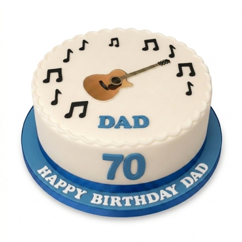 Round white birthday cake with an acoustic guitar and black musical notes on top, with a blue ribbon base.