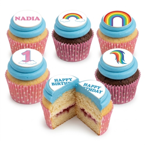 Assortment of rainbow birthday cupcakes with blue frosting, including custom name and age toppers.