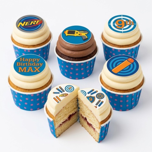 Set of NERF themed cupcakes with blaster, dart, target, and logo toppers, some with custom age and message.