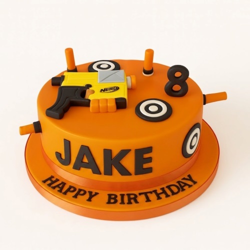 Orange round birthday cake with a yellow and black Nerf blaster, target decorations, and orange dart accents.