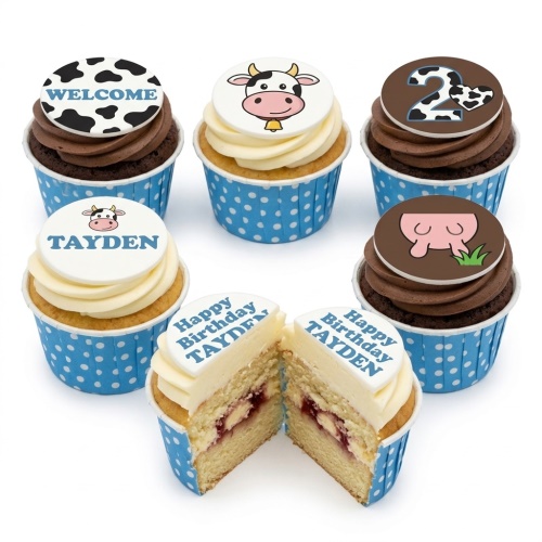 Six farm animal themed cupcakes with cow designs, blue polka dot wrappers, and custom age and name toppers.