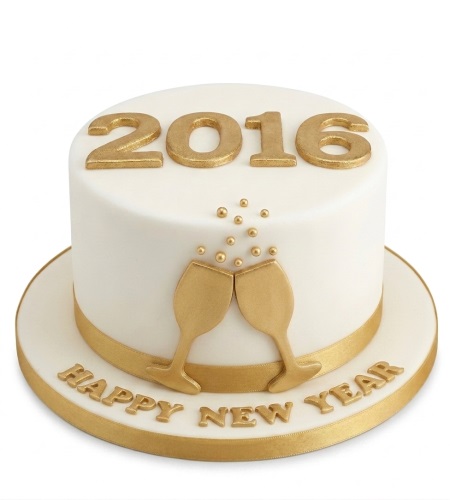 White and gold New Year cake with "Happy New Year" message, champagne glasses, and edible pearls.