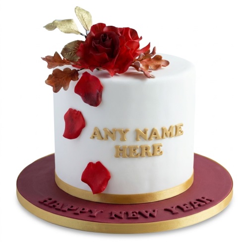 White personalised birthday cake with red rose, golden leaves, and red petals.