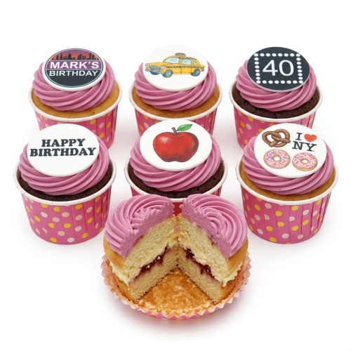 New York City themed birthday cupcakes with pink frosting, taxi, apple, I love NY, and custom toppers.