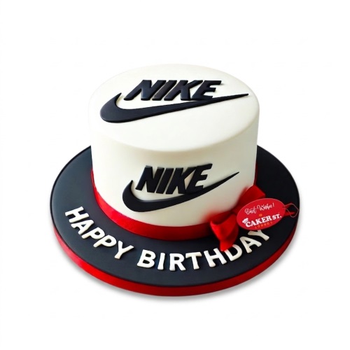 White round single-tier cake with black Nike logos and a red ribbon, on a black cake board with 'Happy Birthday' in white letters.