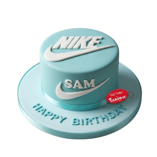 Round light blue cake with white Nike logo and swoosh, with 'Happy Birthday' on the board.