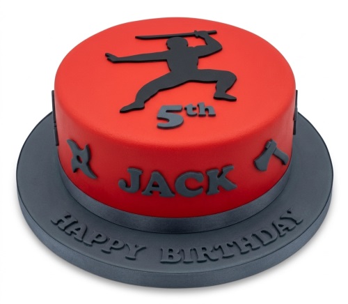 Round red ninja theme birthday cake with black ninja silhouette, shuriken, and axes.