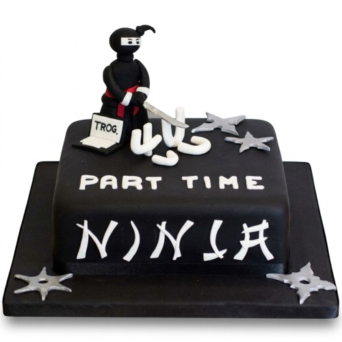 Black square birthday cake with a ninja figure, shurikens, and 'Part Time Ninja' text.