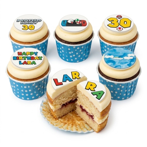 Mario Kart themed birthday cupcakes with custom age and personalised name toppers, in blue polka dot cases.