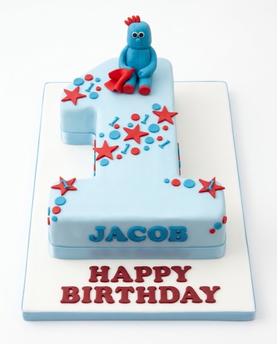 Blue number one shaped cake with Iggle Piggle figure, red stars, and blue dots for a 1st birthday.