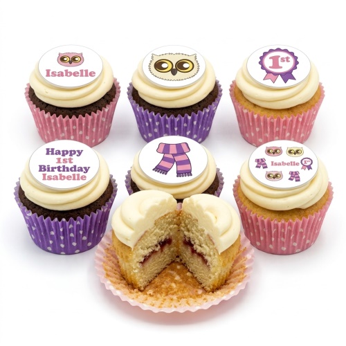 Assortment of owl theme 1st birthday cupcakes with cream frosting, pink and purple cases, and edible toppers.
