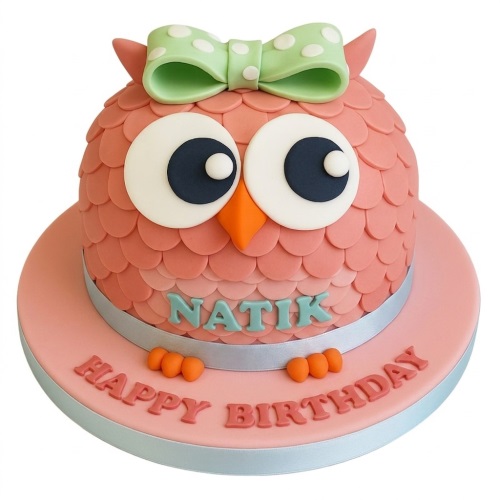 Pink owl birthday cake with green polka dot bow and personalised name.