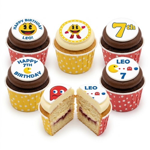 Pac-Man themed birthday cupcakes with yellow and red polka dot cases, featuring Pac-Man and ghost toppers, some with custom age and name.