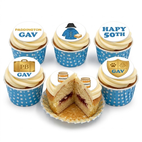 Paddington Bear themed birthday cupcakes with custom age and name toppers, blue polka dot wrappers.