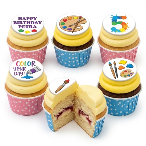Selection of art theme cupcakes with yellow frosting, paint palette, brush, paint tube, and custom age toppers in pink and blue wrappers.
