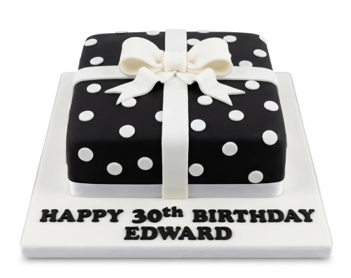 Black and white gift box birthday cake with white polka dots, a white ribbon, and a bow.