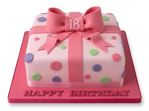 Pink gift box birthday cake with a large bow and pastel polka dots, featuring a custom age topper.