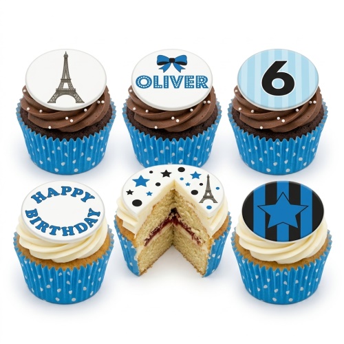 A set of blue and white cupcakes with chocolate and vanilla frosting, featuring custom age, name, Eiffel Tower, and star toppers.