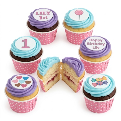 Colourful cupcakes with light blue and purple icing, topped with sweet-themed decorations, hearts, and custom age/name toppers in pink polka dot wrappers.