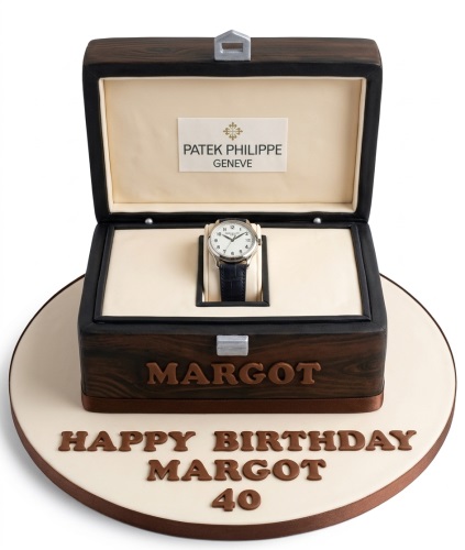 3D Patek Philippe watch box cake with an edible watch inside, on a white cake board with custom name and age.