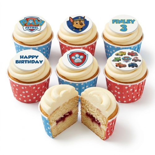 Paw Patrol themed cupcakes with white frosting, red and blue polka dot cases, and edible Paw Patrol toppers.