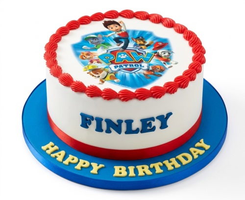 Round white Paw Patrol birthday cake with red piping, blue name, and yellow "Happy Birthday" message.
