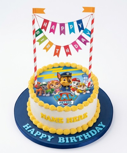 Round white Paw Patrol birthday cake with yellow piping, character image, and Happy Birthday bunting.