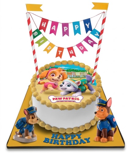 White Paw Patrol birthday cake with Skye, Everest, and Chase figurines, Happy Birthday bunting.