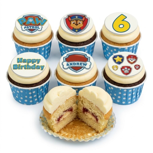 Paw Patrol themed cupcakes with Chase, Paw Patrol logo, and custom age/name toppers in blue polka dot wrappers.