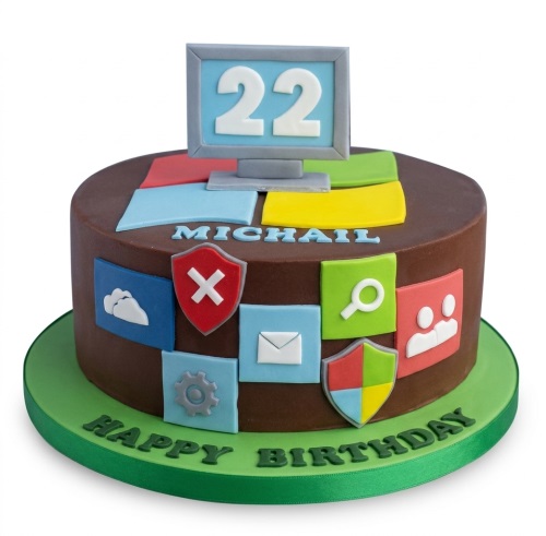 Round chocolate-coloured birthday cake with colourful app icons, a computer monitor topper displaying a custom age, and green "Happy Birthday" text.